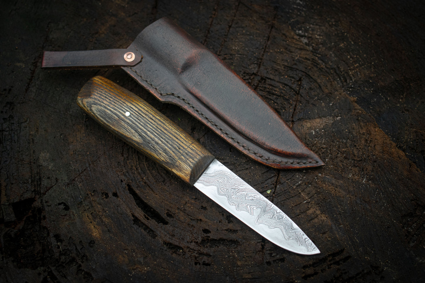 Handcrafted Bushcraft Knife with Damascus San Mai Blade and Aged Leather Sheath